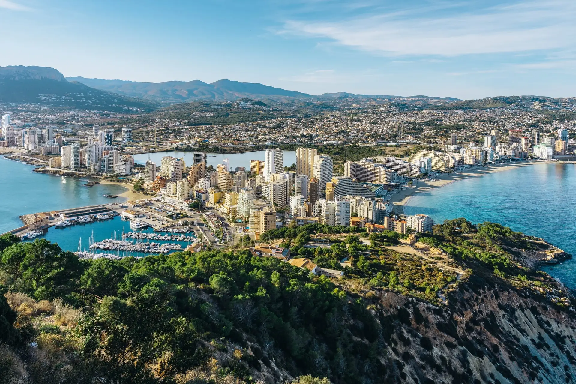 A breathtaking viewpoint in Calpe, Costa Blanca, Spain, showcasing panoramic views of the Mediterranean Sea, rocky coastline, and the iconic Peñón de Ifach.