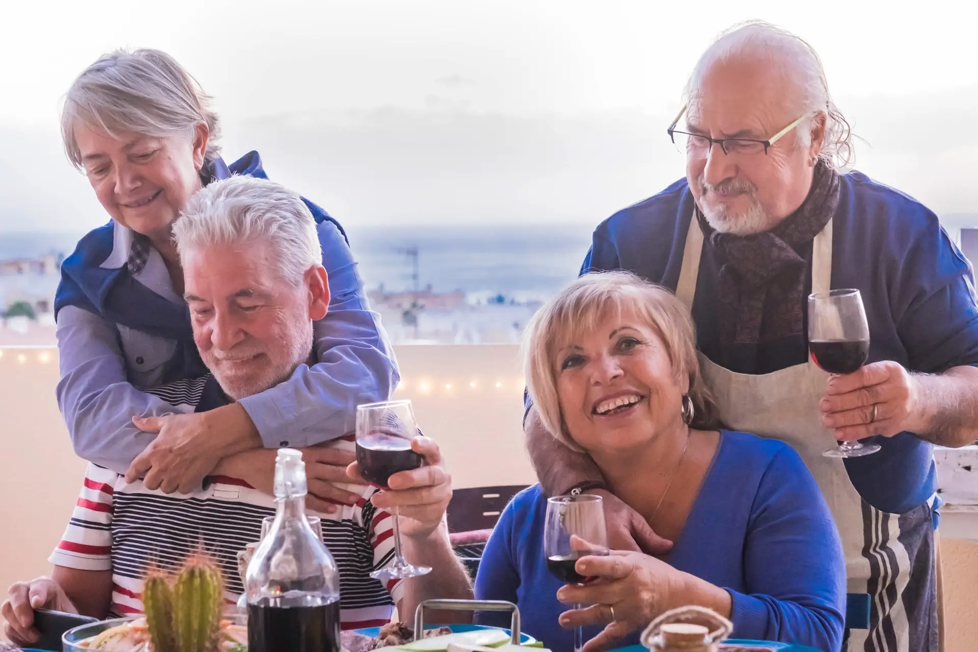 A group of senior expats dining together outdoors, enjoying their retirement with peace of mind thanks to 247 Expat Insurance.