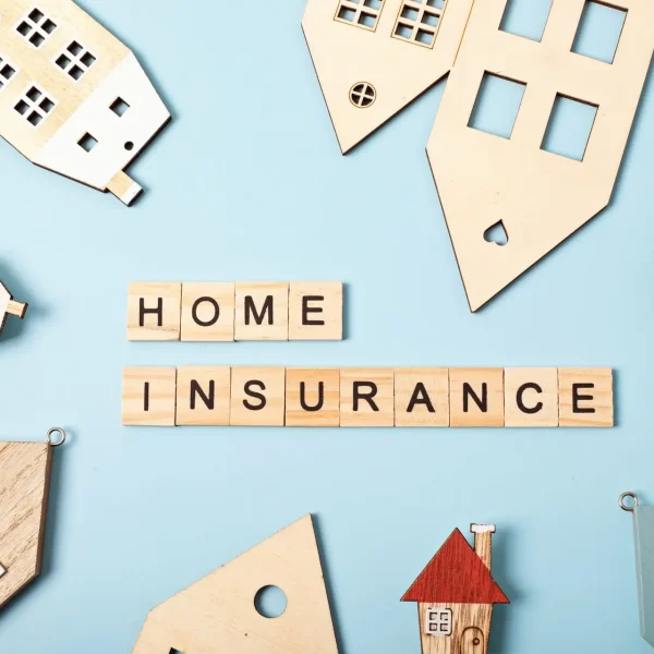 Home Insurance Protection – Secure Your Home Today A home insurance message with small wooden houses on a blue background, symbolizing protection, security, and peace of mind.